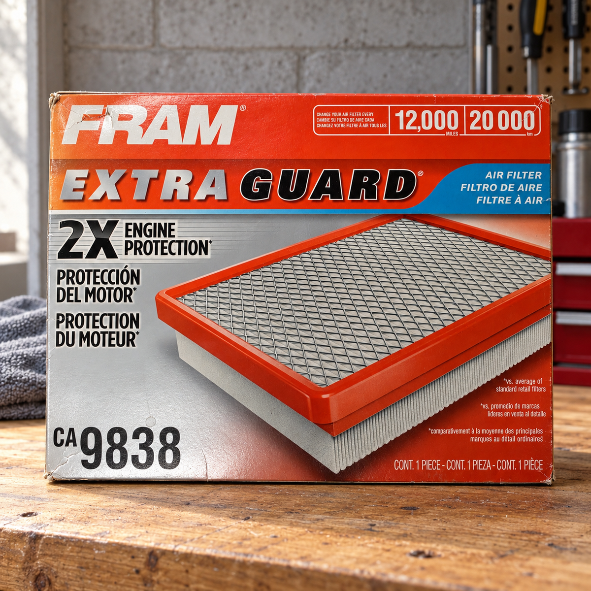 FRAM CA9838 Extra Guard box on a DIY maintenance bench lifestyle scene; AI-staged composite.