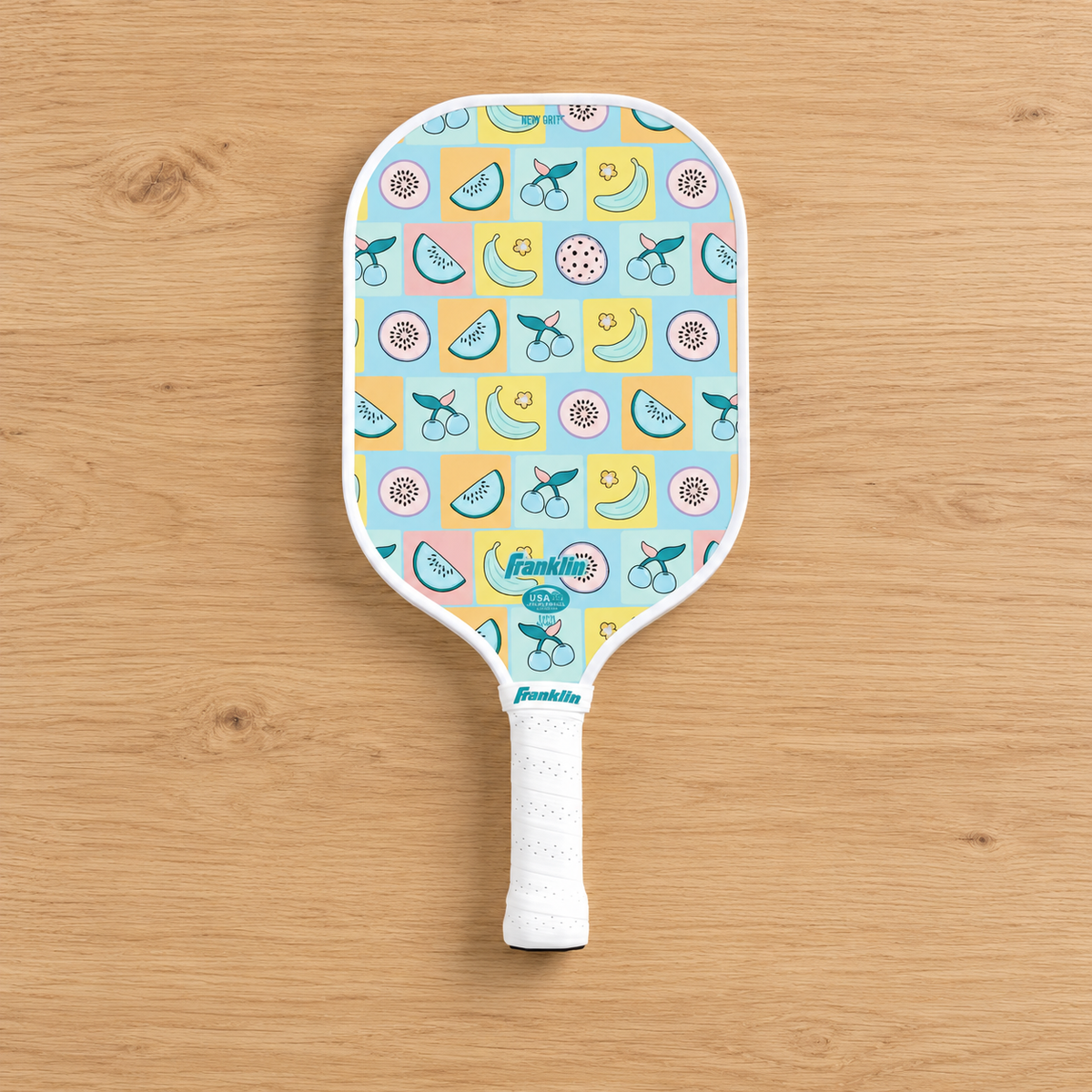AI-generated presentation of the Franklin junior fruit pickleball paddle on an oak tabletop