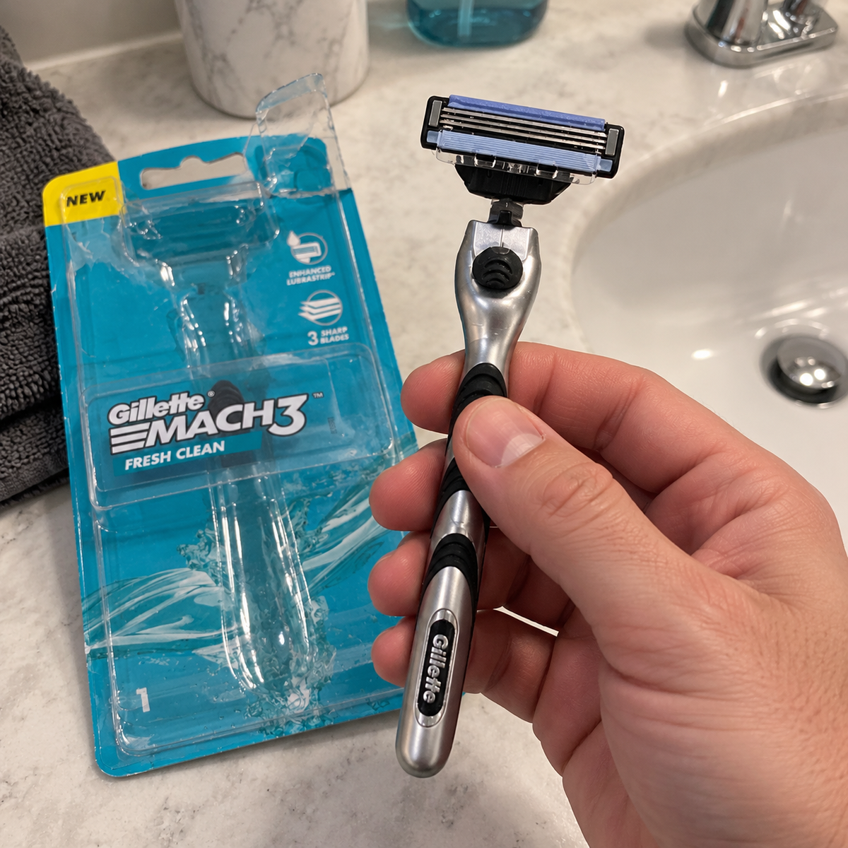 Lifting a Gillette MACH3 Fresh Clean razor from its opened retail pack