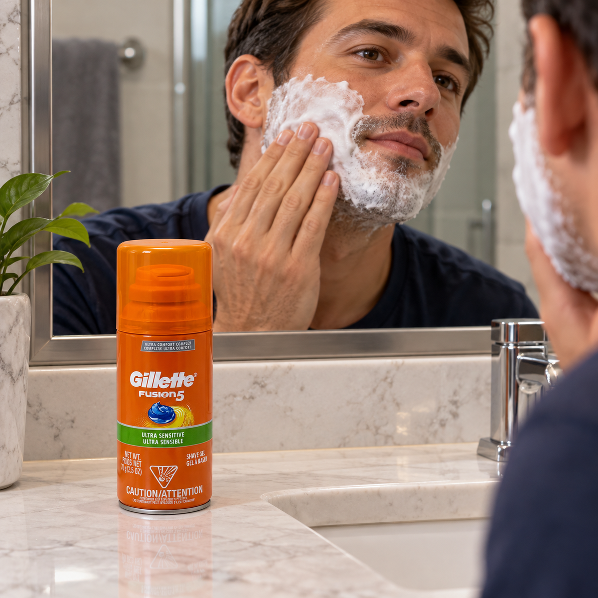 Applying shaving lather with a small Fusion5 Ultra Sensitive can beside the sink