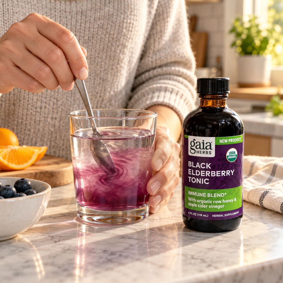 Stirring Gaia Black Elderberry Tonic into a glass of water