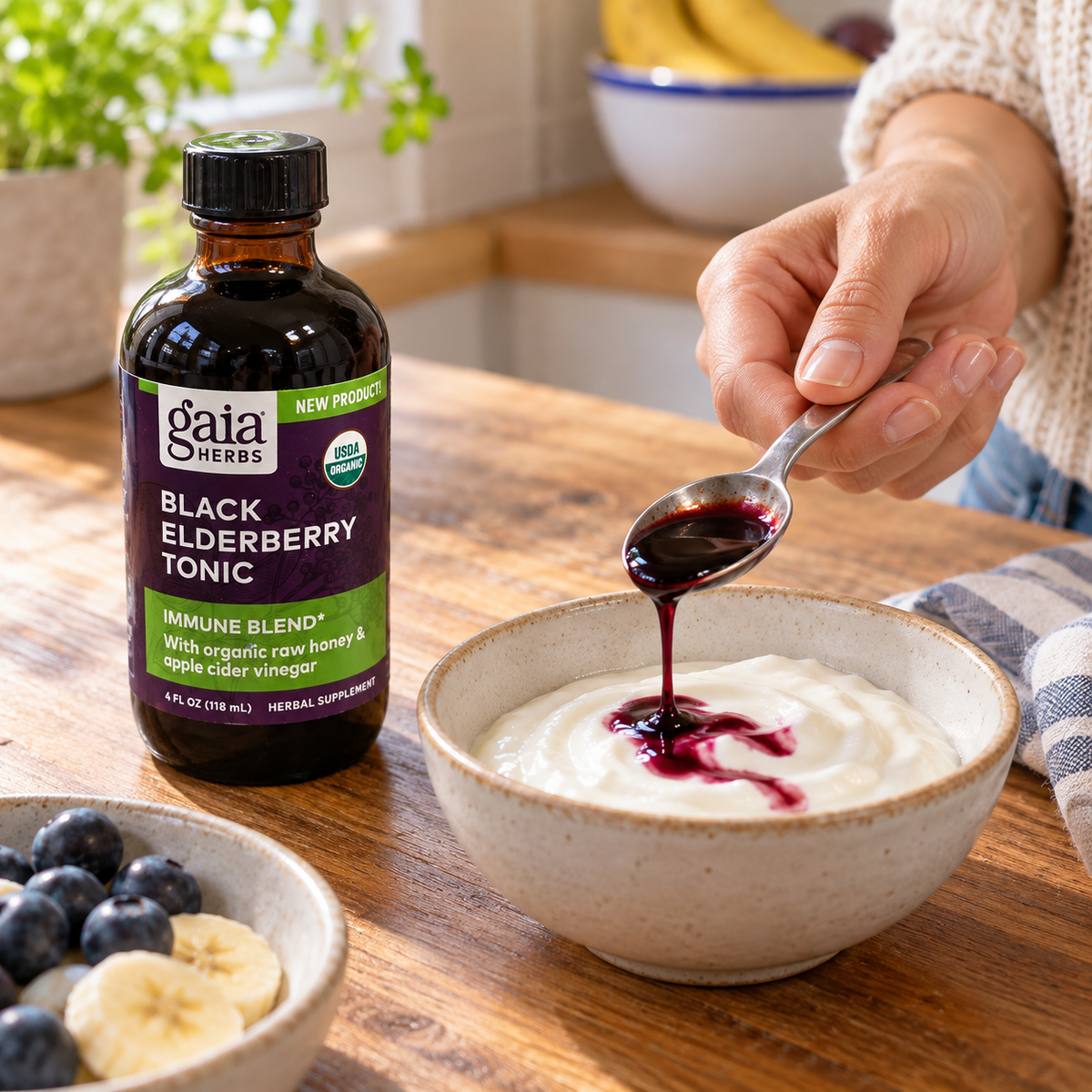 Adding a spoonful of Gaia Black Elderberry Tonic to plain yogurt