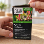 Hands opening a Gaia Herbs Quick Defense 40-count carton.