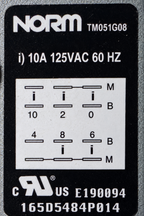 Close detail of the stocked GE dishwasher timer rating label showing NORM TM051G08, 10A 125VAC 60Hz and terminal diagram