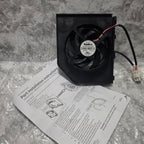 Actual inventory photo: GE WR60X23363 fan assembly, original Nidec motor label, wiring connector and included instruction sheet
