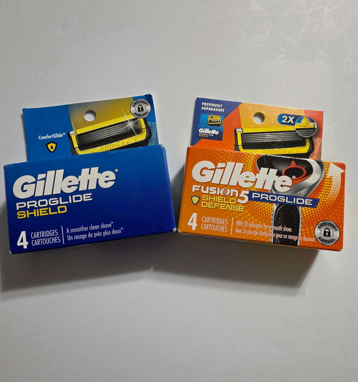 Actual More4less Outlet photo of blue and orange Gillette ProGlide Shield 4-cartridge packaging; each purchase is one 4-count pack
