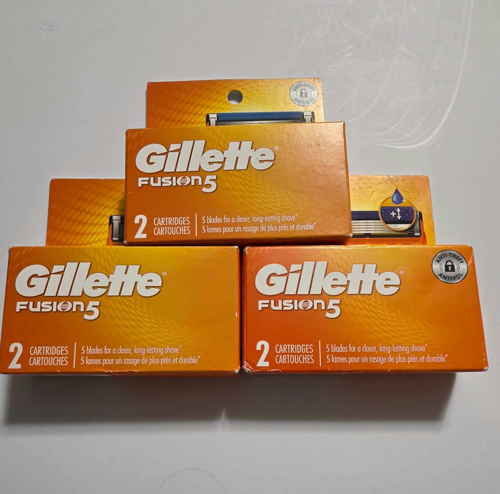 Three Gillette Fusion5 two-count boxes, six cartridges total, with carton edge wear