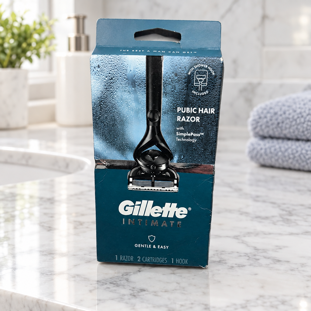 Gillette Intimate razor kit in its original blue box on a marble bathroom vanity beside folded towels