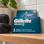 Gillette MACH3 Original 5-cartridge refill pack on an oak bathroom shelf; styled lifestyle scene
