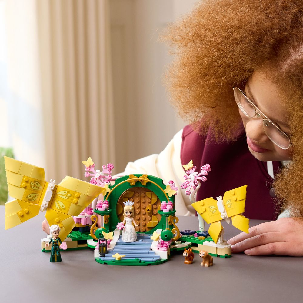 Child positioning the butterfly elements around the completed LEGO Wicked Glinda’s Wedding Day 75688 wedding scene.