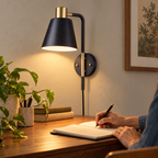 Styled Lex 51660 black-and-brass sconce illuminating journal writing at a small desk