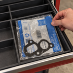 The packaged GM gasket placed flat in a garage storage drawer.