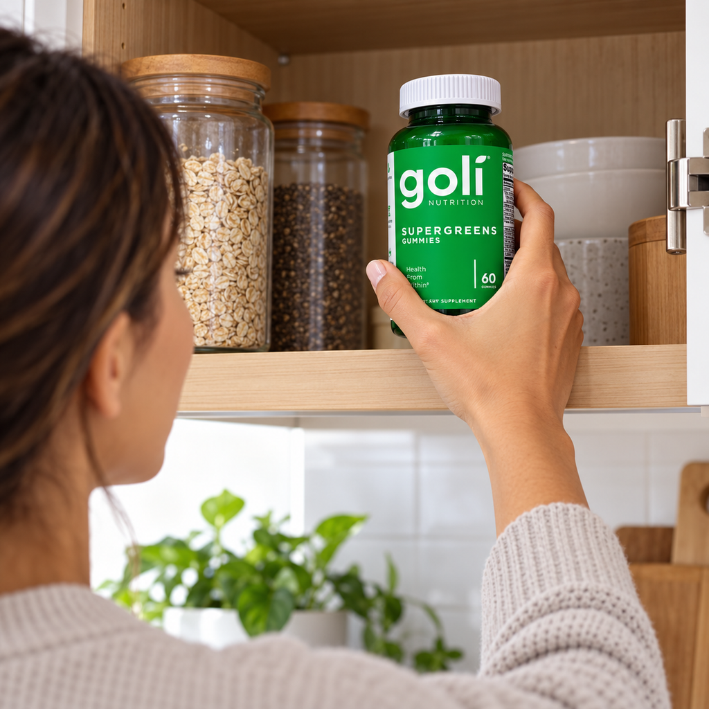 Taking Goli Supergreens gummies from an upper cupboard