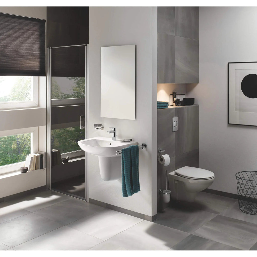 Manufacturer bathroom scene showing GROHE Essentials 40371001 single-post swivel towel bar near a basin; surrounding fixtures and towel not included.
