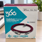 AI-generated lifestyle illustration of one closed HabitatCharge cranberry 4 ft USB-A to Lightning cable box in a desk setting; background props not included.
