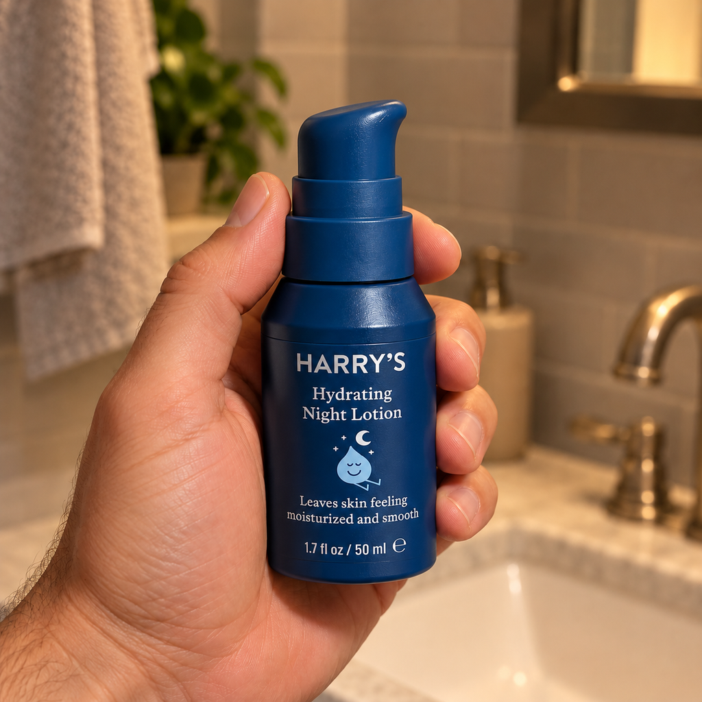 Adult holding a 1.7 fl oz bottle of Harry's Hydrating Night Lotion