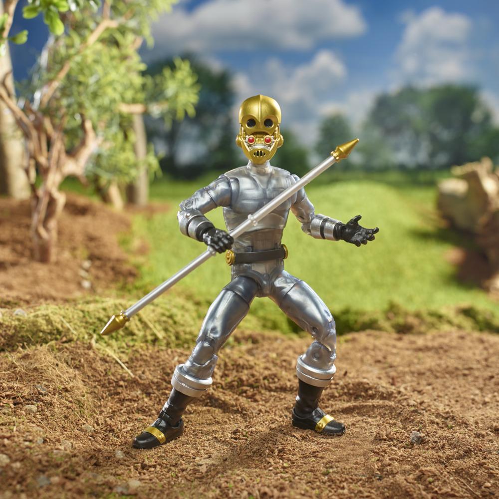 Zeo Cog figure with the open alternate head holding the extended staff in an outdoor display scene