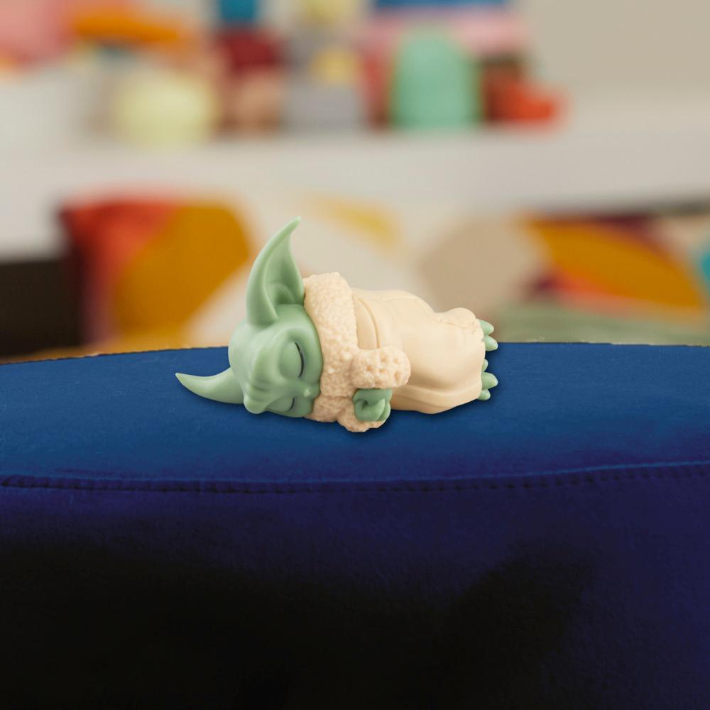 Close-up manufacturer view of the sleeping Grogu figure included in the Taming the Beast Pack