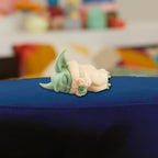 Close-up manufacturer view of the sleeping Grogu figure included in the Taming the Beast Pack