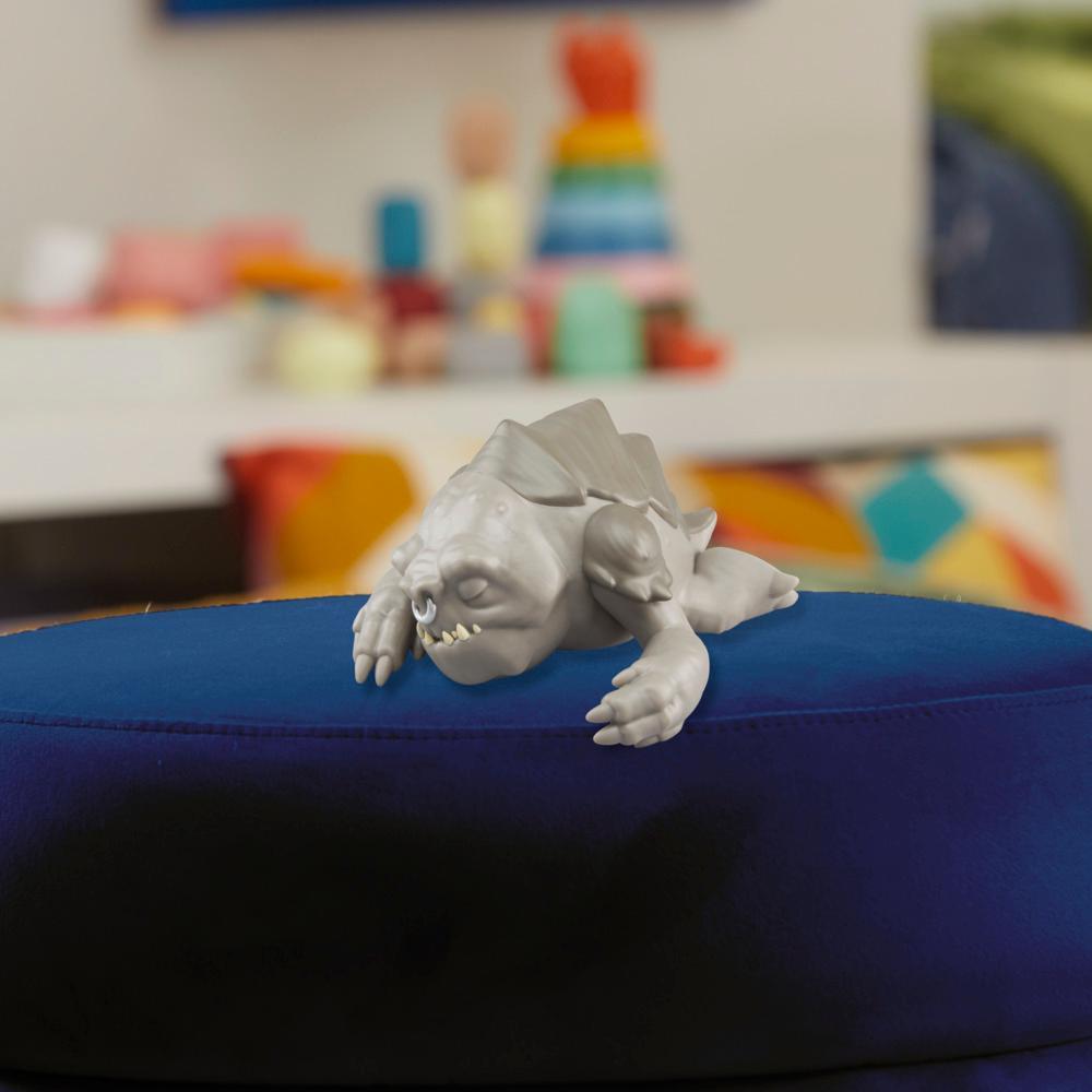 Close-up manufacturer view of the sleeping Rancor figure included in the Grogu and Rancor Taming the Beast Pack
