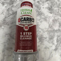 Herbal Clean QCarbo16 Dragon Fruit 16 fl oz bottle with red label on a marble background