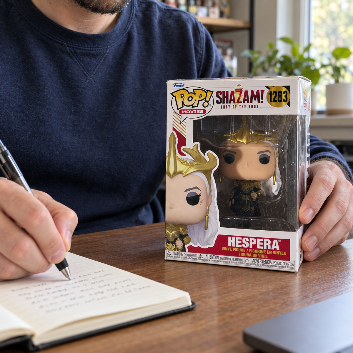 Boxed Funko Pop! Hespera #1283 being recorded in a collector's notebook.