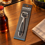 Illustrative packaged Houdini bottle opener on an oak bar counter; soda bottle and napkin not included.