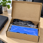 AI-generated unpacking table scene of the HP USB-C Dock G4 in its open carton with bagged contents.