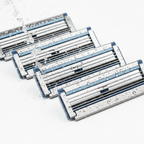 Premium steel razor blades glistening under focused water spray macro shot