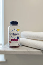 Citracal Calcium D3 Gummies bottle on neutral grey minimalist bathroom shelf