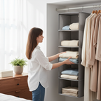Woman placing folded sweaters into grey fabric hanging shelves on closet rod in bright bedroom, home organization lifestyle