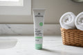 Arbonne Instant Cooling Moisture Mask on marble bathroom counter with white towels spa lifestyle