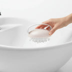 Professional close-up of handheld beauty massage accessory with nodule tips ready for spa routine at home