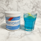 AdvoCare Rehydrate tub on marble with berry lemon ice drink and fresh lemon slices – More4less Outlet