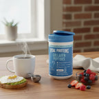 Vital Proteins Collagen Peptides tub in morning coffee setting with steaming mug and breakfast on wooden table.