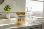 Nature's Bounty Probiotic CD box on bathroom vanity with natural sunlight and water carafe