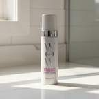 Color Wow Bombshell Volumizer white pump bottle in soft natural window light on white quartz bathroom countertop – More4less Outlet