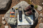 BlendJet JetSetter black water-repellent blender carrier in professional hiking gear flat lay on trail rock