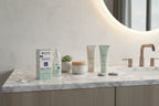 Garnier Green Labs Retinol-Berry Serum Cream on a modern white marble bathroom vanity with organized nighttime skincare items