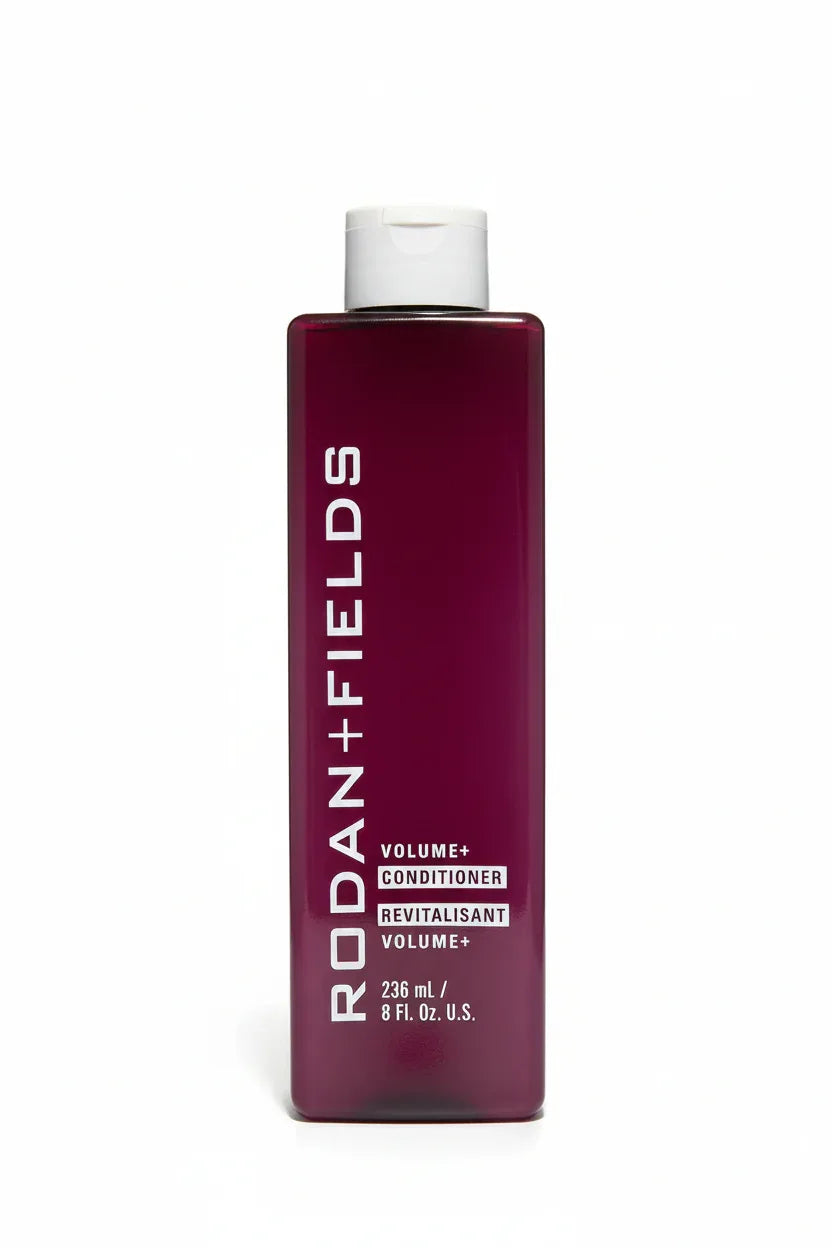 Rodan + Fields Volume+ Conditioner bottle on bright white studio background professional haircare photography