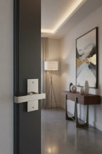 Baldwin Reserve contemporary half-dummy door lever on charcoal interior door in modern living room