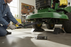 Person installing MTD 30-inch mulching blade on riding lawn tractor deck — star center hole replacement blade for Troy-Bilt and Yard-Man