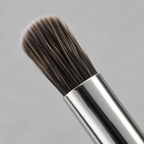AI-generated close-up detail of the angled eye crease brush head on the Mary Kay dual-ended brush
