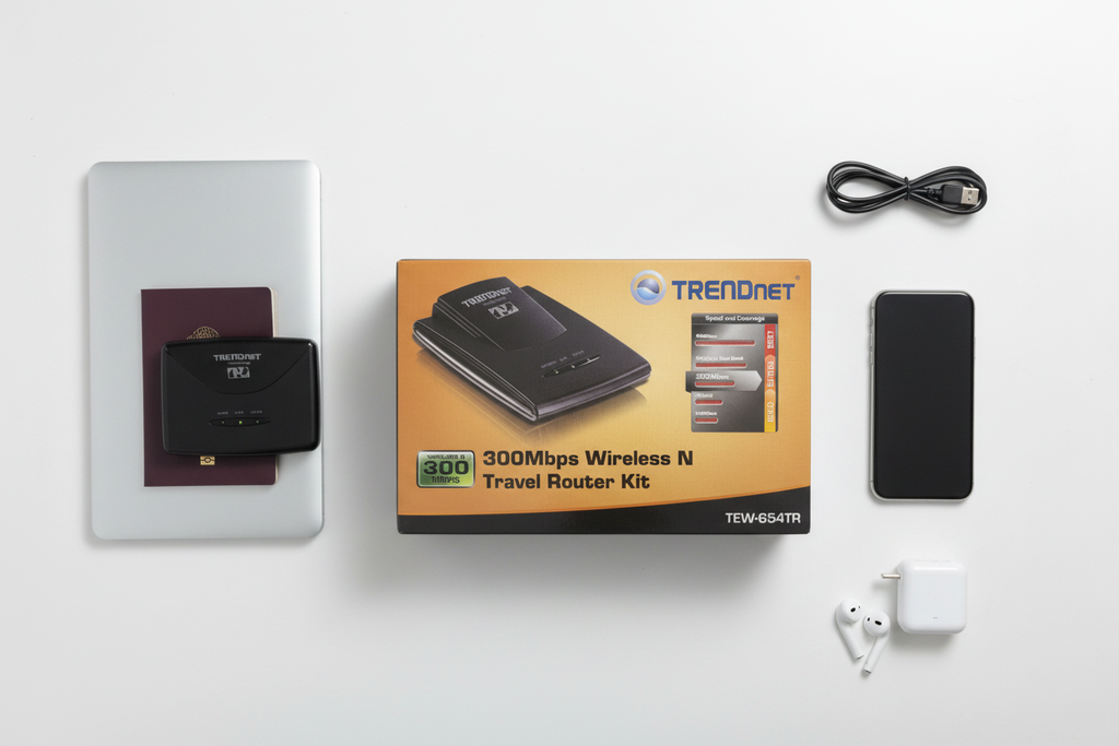 TRENDnet TEW-654TR 300Mbps Wireless N Travel Router Kit flat lay with laptop passport earbuds and phone travel essentials – More4less Outlet