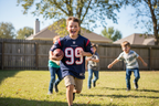 Young boy wearing J.J. Watt Houston Texans #99 youth jersey playing backyard football on sunny day – More4less Outlet