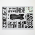 AMT Batman and Robin Batmobile model kit parts flat lay showing plastic sprues vinyl tires decal sheet and Batman figure before assembly