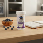 Garden of Life Mood Daily Care Probiotics bottle on light-wood kitchen breakfast island with wooden bowl of organic blueberries and wellness planner