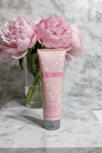 Mary Kay Be Delighted Body Wash 4 fl oz on marble bathroom counter with pink peonies – spa lifestyle – More4less Outlet