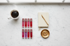 Manna Kadar pH Balance Lip Oil Set minimalist morning beauty routine flat lay marble — More4less Outlet