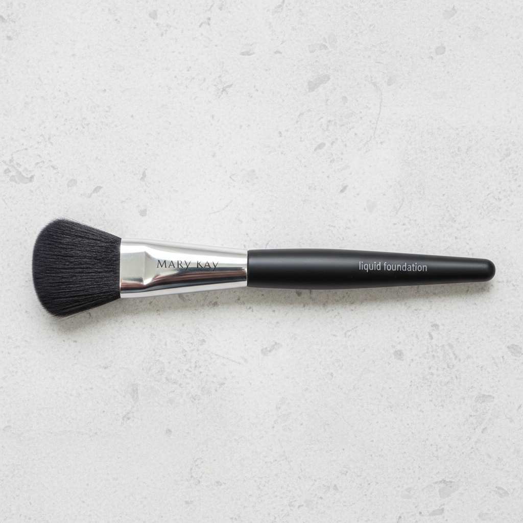Mary Kay Classic Flat Paddle liquid foundation brush on a light stone surface